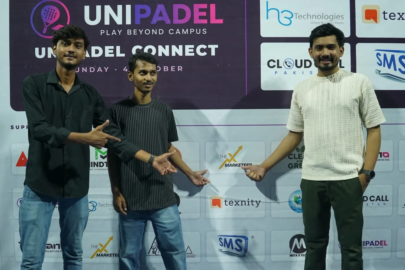 UniPadel team in front of the UniPadel Connect sponsors and partners wall